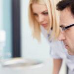 2 scientists looking at a screen