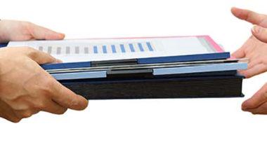 Handing over a stack of papers