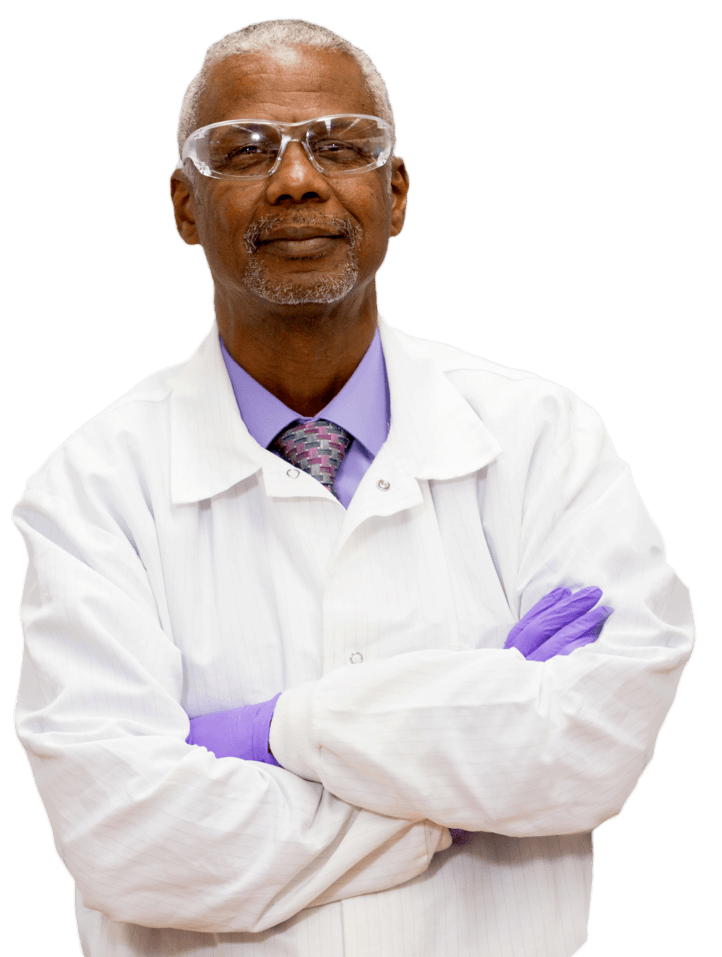 Male doctor wearing safety glasses standing with his arms crossed.