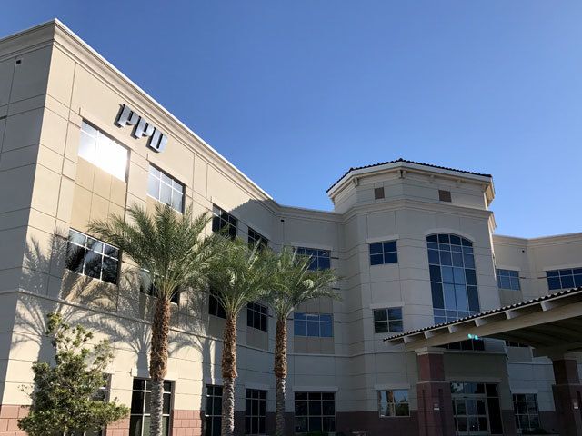 exterior of a ppd building with palm trees out front