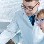 two scientists collaborating at a computer