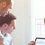 coworkers reviewing data together on a computer