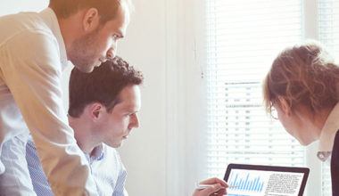 coworkers reviewing data together on a computer