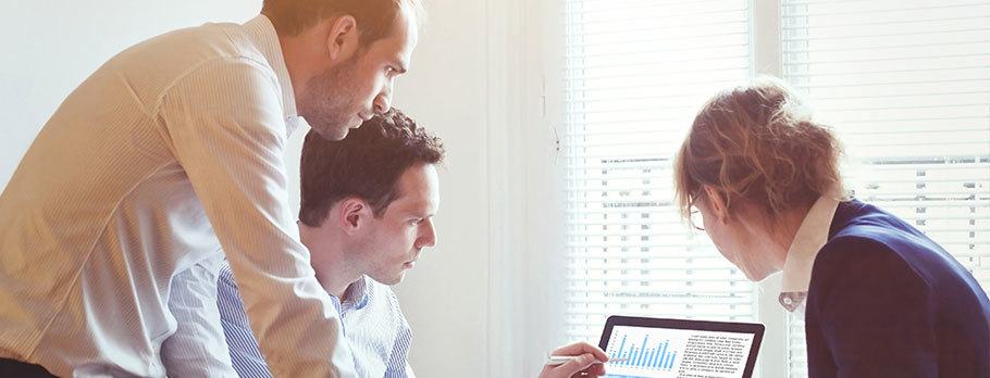 coworkers reviewing data together on a computer