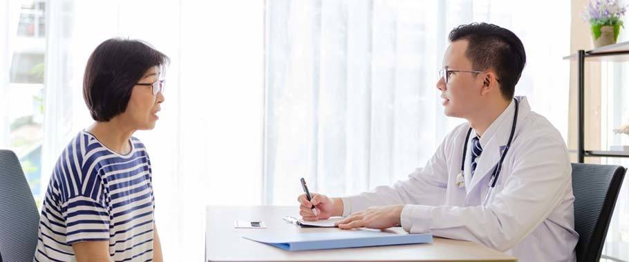 doctor going over paperwork with his patient