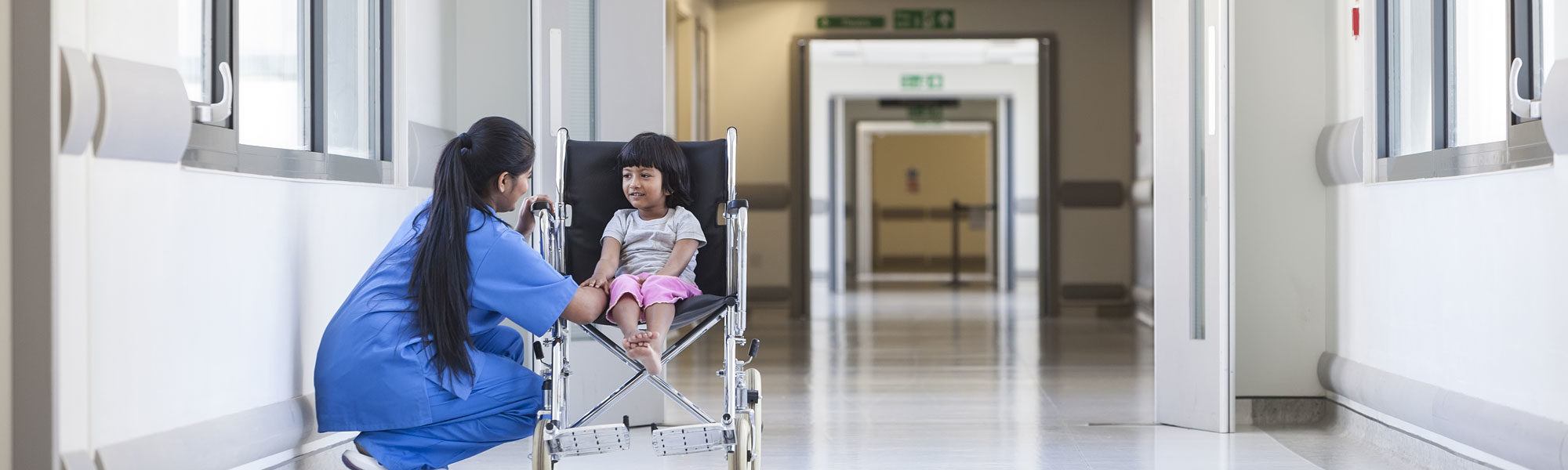 Child in wheelchair with nurse
