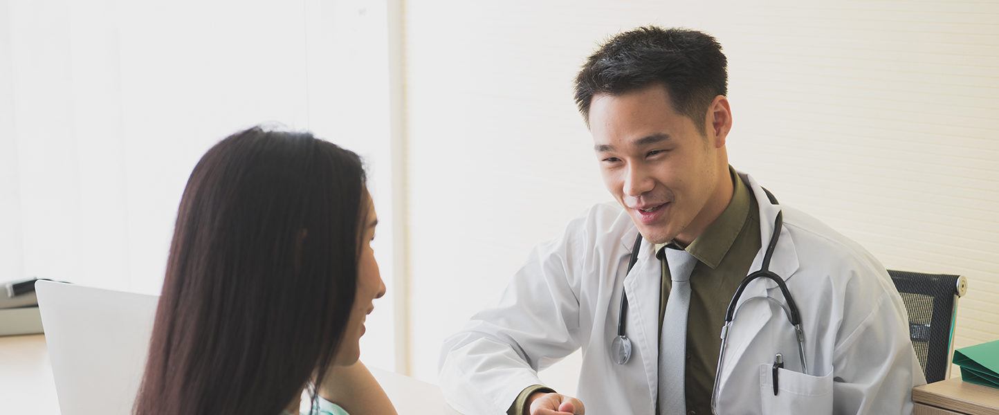 A male doctor speaking with his patient