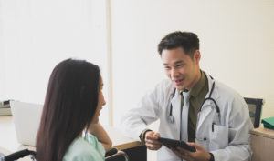 A male doctor speaking with his patient