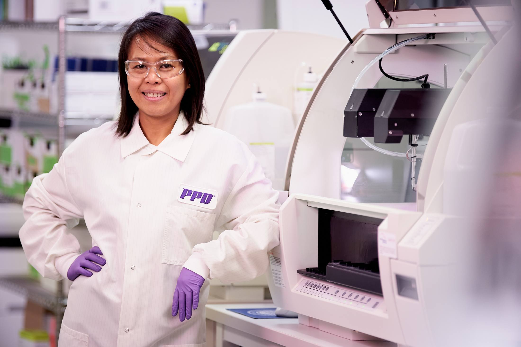 female scientist posing with lab equipment
