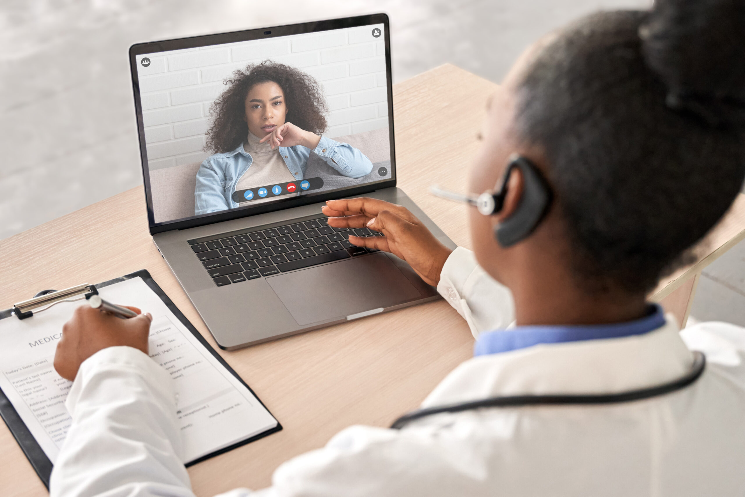 Woman at computer exploring global clinical trial barriers.