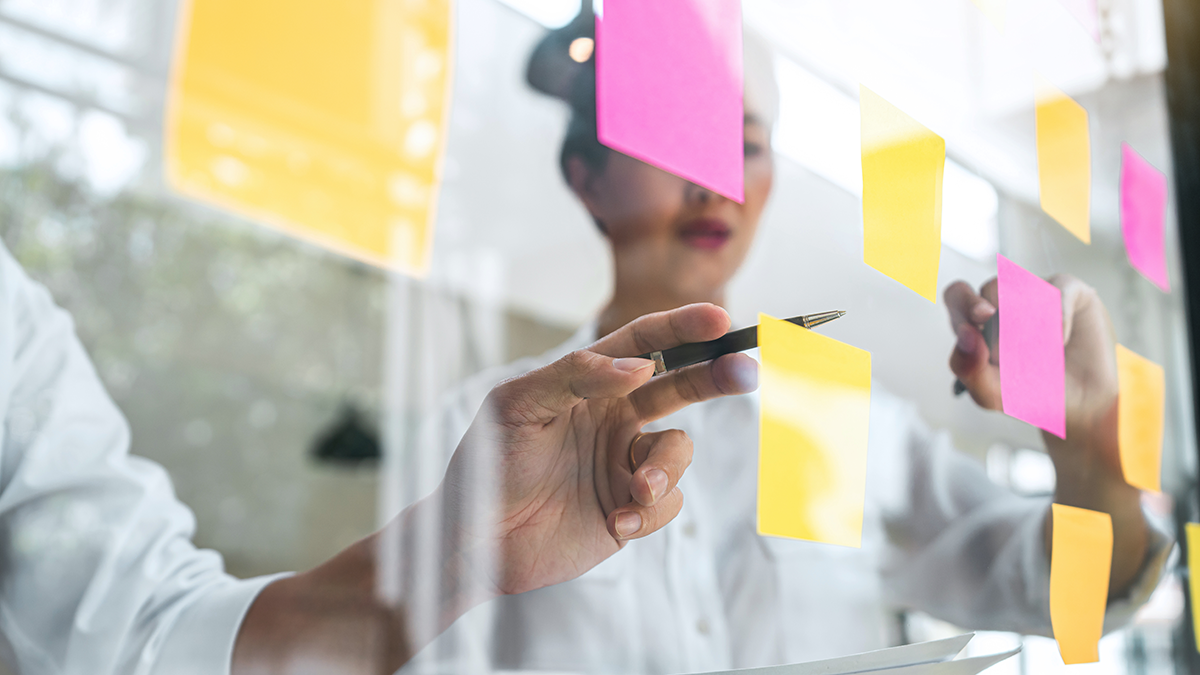 woman brainstorming with sticky notes