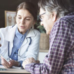 A doctor conducts a qualitative interview with a patient during a clinical trial