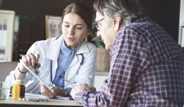 A doctor conducts a qualitative interview with a patient during a clinical trial