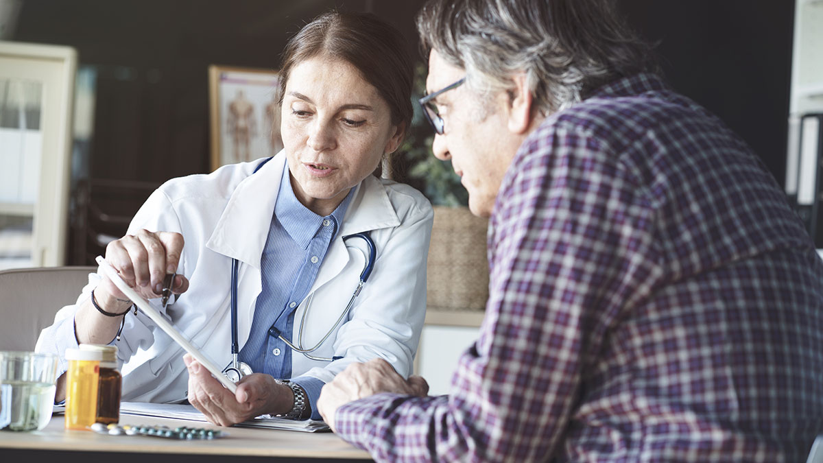 A doctor conducts a qualitative interview with a patient during a clinical trial