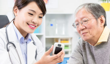 Doctor shows diabetes blood sugar test result to patient