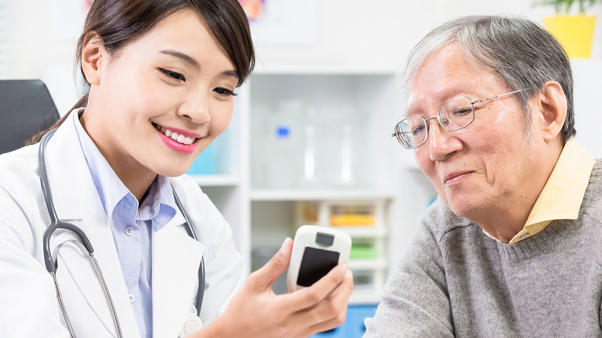 Doctor shows diabetes blood sugar test result to patient