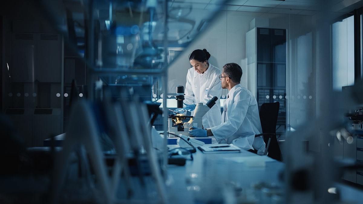 Two scientists working in a medical laboratory facility