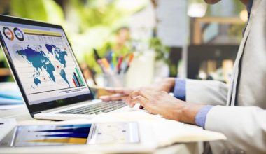 Doctor analyzing stats and graphs on a laptop