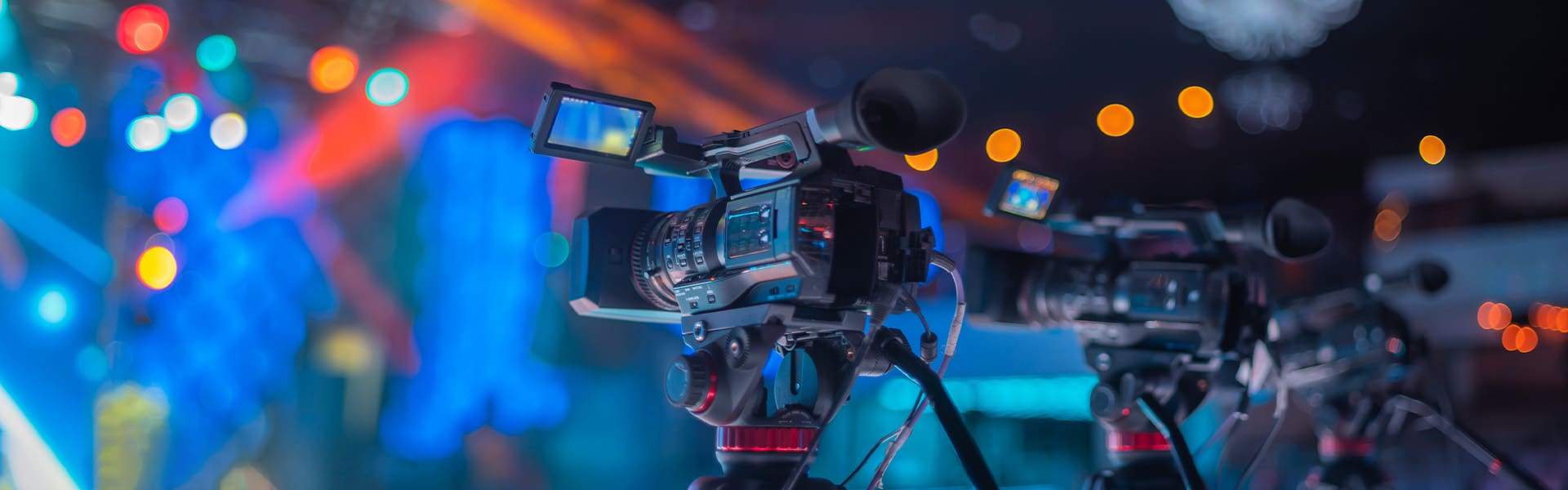 Newsroom of cameras and stage lighting.