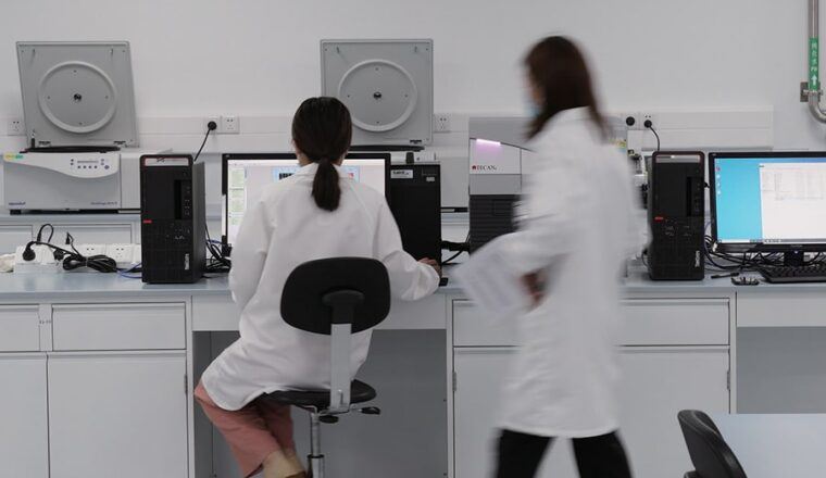 Two lab technicians in a bioanalytical laboratory.