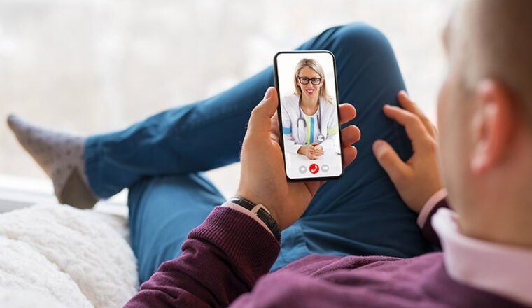 Patient speaking to a doctor on a phone via televisit