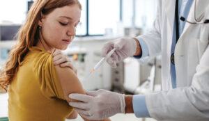 Young women getting a vaccine.