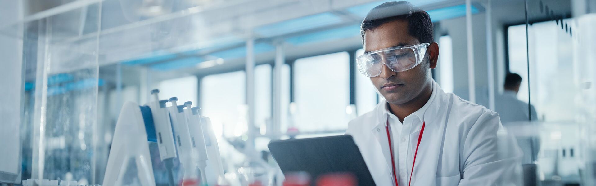 lab-technician-reading-tablet-data