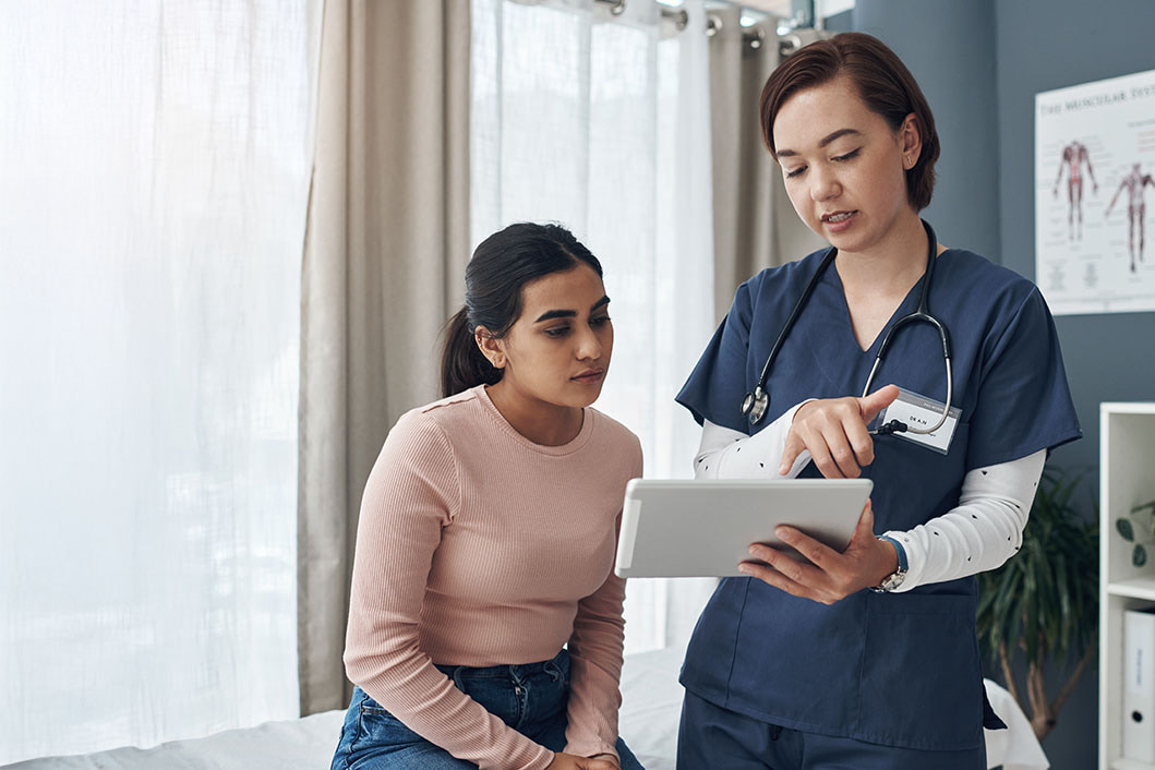 Physician speaking to a patient in a treatment room
