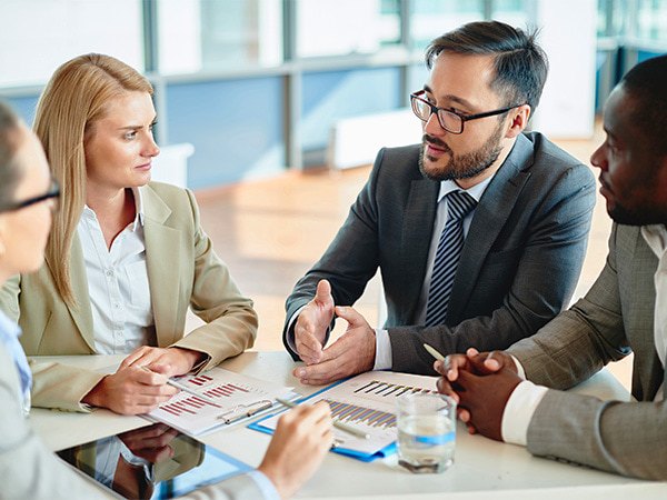 Professionals meeting discussing trends in clinical trials.