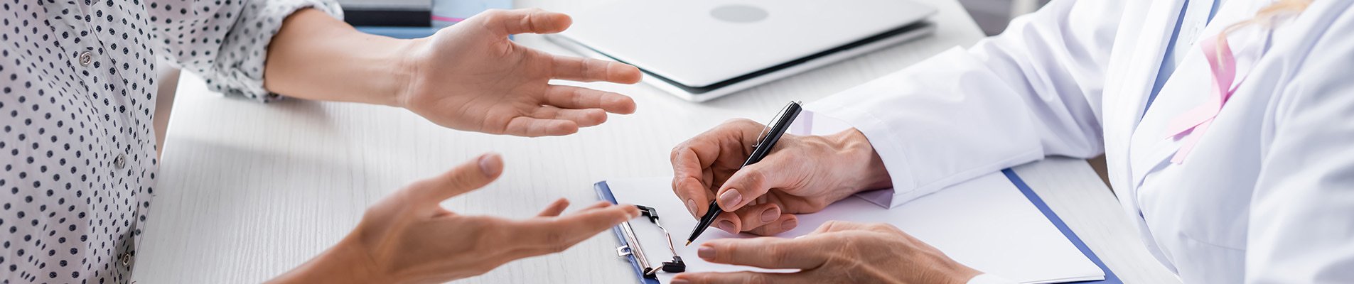 Oncology clinical trial patient speaking to a physician.