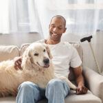 Man with Myasthenia Gravis disease petting dog