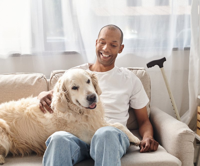 Man with Myasthenia Gravis disease petting dog