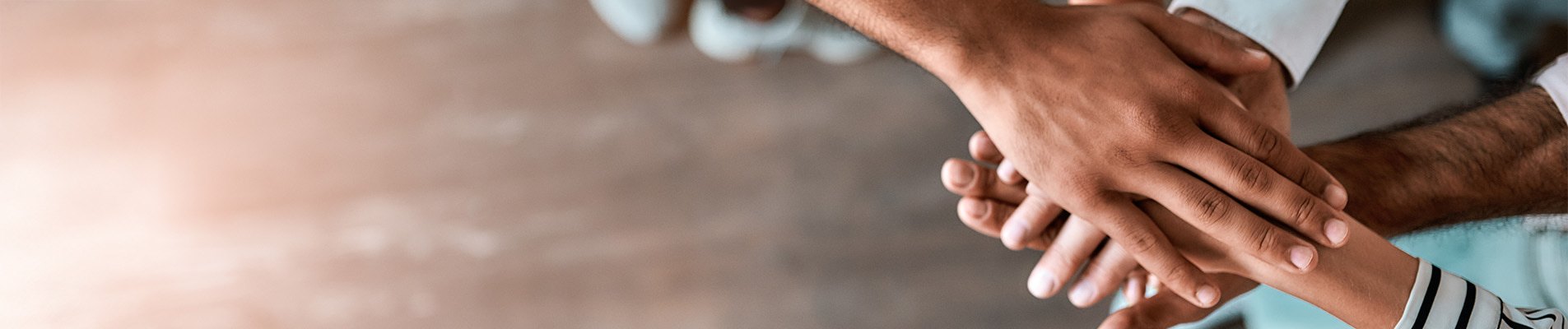 Psychiatry group of people stacking their hands in support.