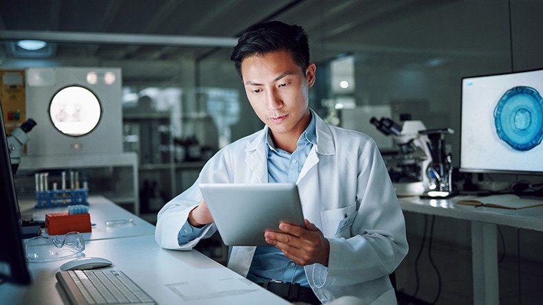 Precision medicine laboratory specialist reviewing evidence strategy.